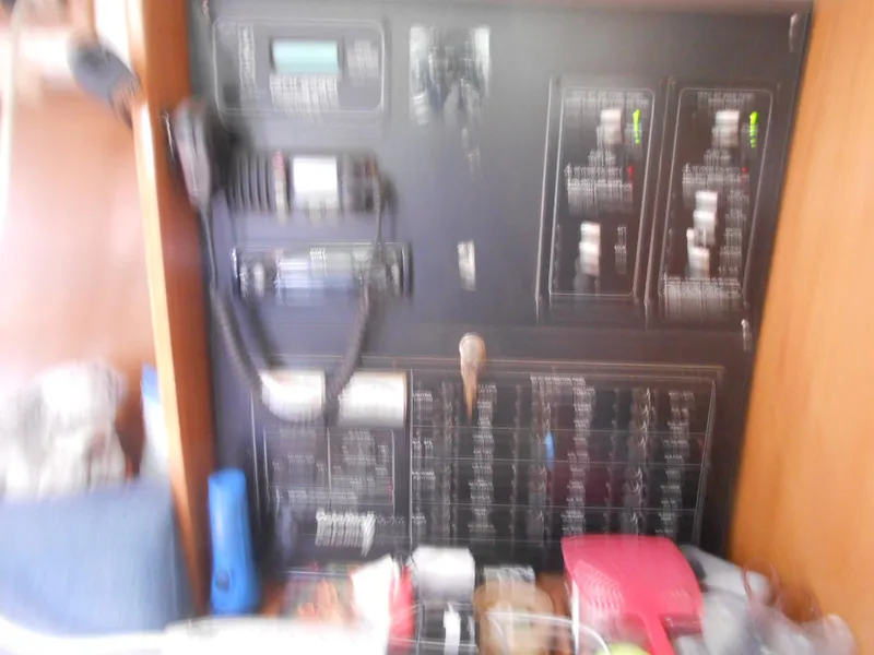Slide: The Image of Blurred control panel inside a 2004 Catalina 387 sailboat, featuring various switches and equipment. - 27