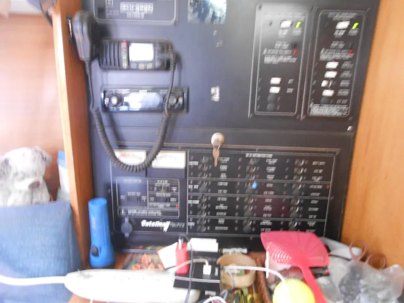 Slide: The Image of Electrical panel inside a 2004 Catalina 387 yacht, featuring communication equipment and various controls. - 28