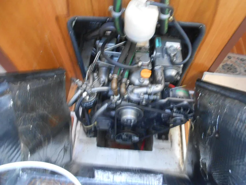 Slide: The Image of Engine compartment of a 2004 Catalina 387 sailboat, showcasing mechanical components and wiring. - 29