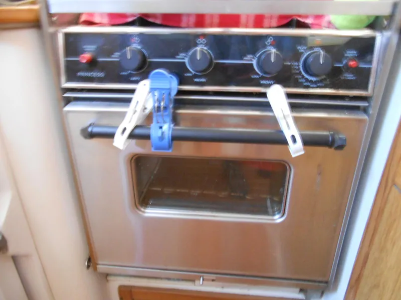 Slide: The Image of Stainless steel oven with clothespins on handle, inside a 2004 Catalina 387 boat. - 31