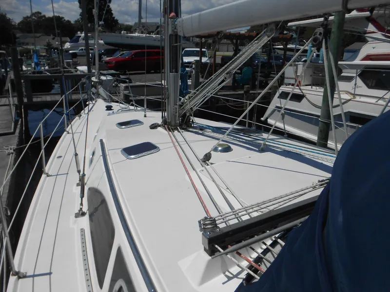 Slide: The Image of 2004 Catalina 387 sailboat deck with rigging, docked at marina. - 34
