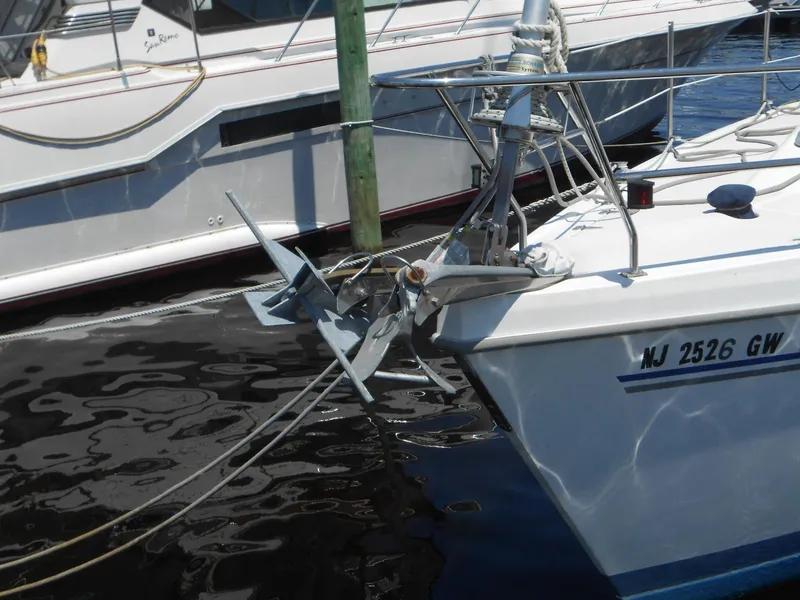 Slide: The Image of 2004 Catalina 387 sailboat docked with visible anchor and registration number NJ 2526 GW. - 6