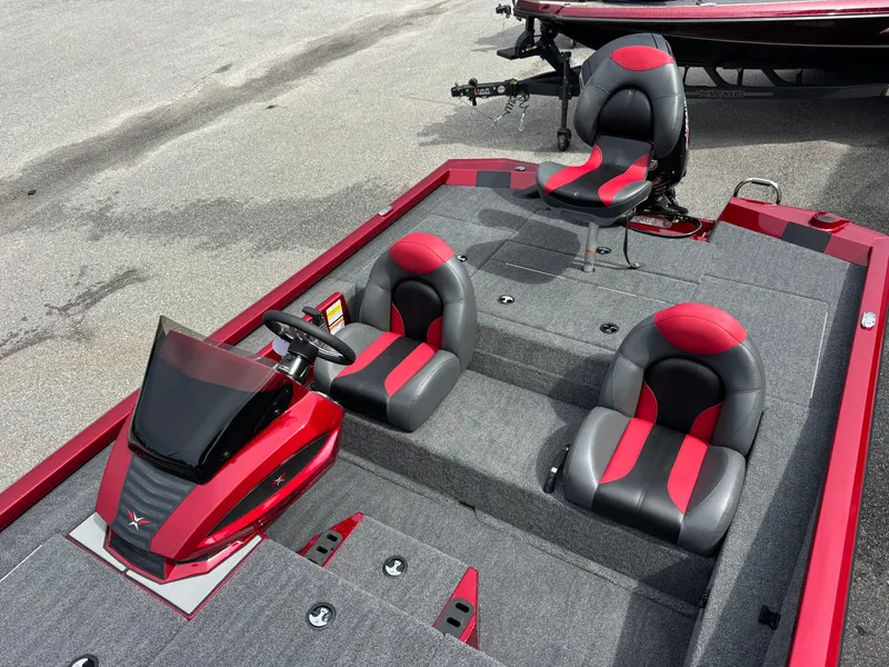 Slide: The Image of 2026 Vexus AVX1880 boat interior with red and black seating, steering console, and carpeted deck. - 11