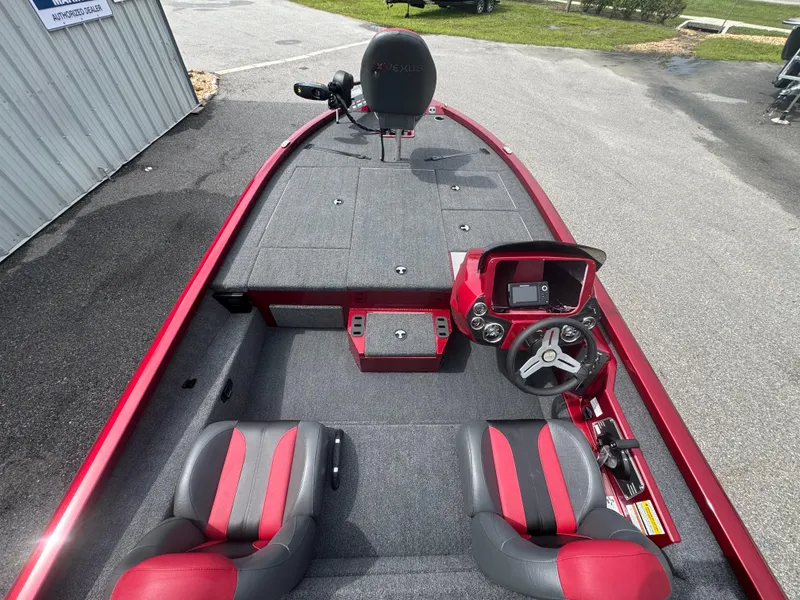 Slide: The Image of 2026 Vexus AVX1880 boat interior with red and black seats, steering console, and spacious deck. - 18