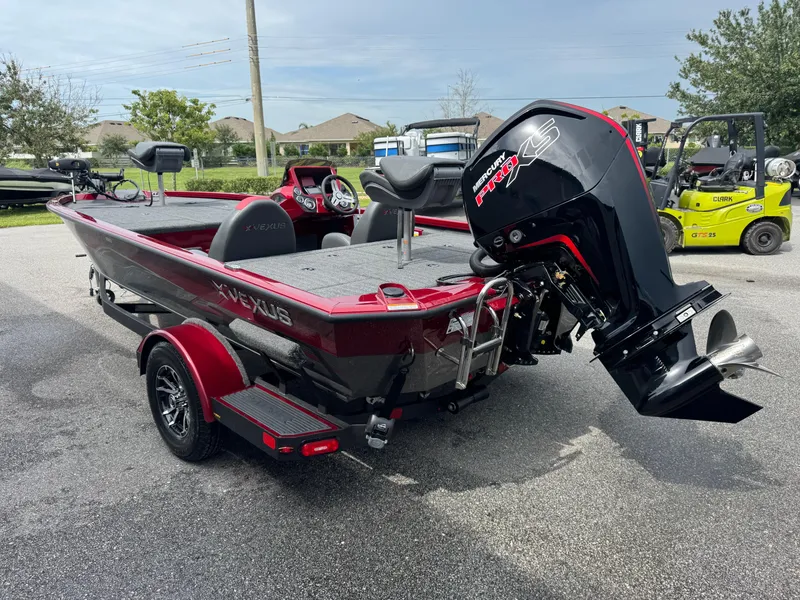 Slide: The Image of 2026 Vexus AVX1880 boat with Mercury Pro XS engine, parked outdoors. - 19