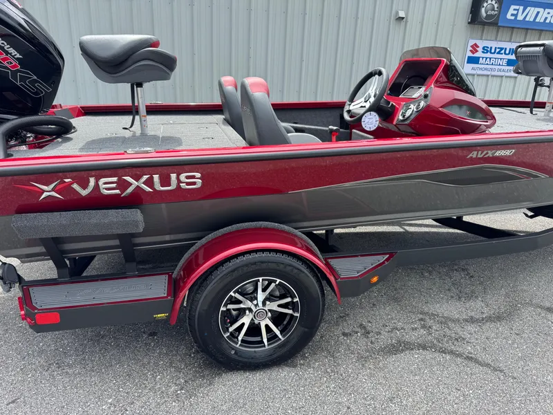 Slide: The Image of 2026 Vexus AVX1880 boat with red and gray design, featuring comfortable seating and modern controls. - 2