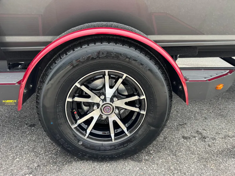 Slide: The Image of 2026 Vexus AVX1880 trailer wheel with black alloy rim and red fender. - 4