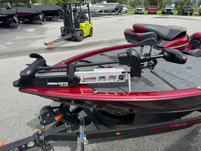 Slide: The Image of 2026 Vexus AVX1880 boat with Minn Kota Ultrex trolling motor in a parking lot. - 6