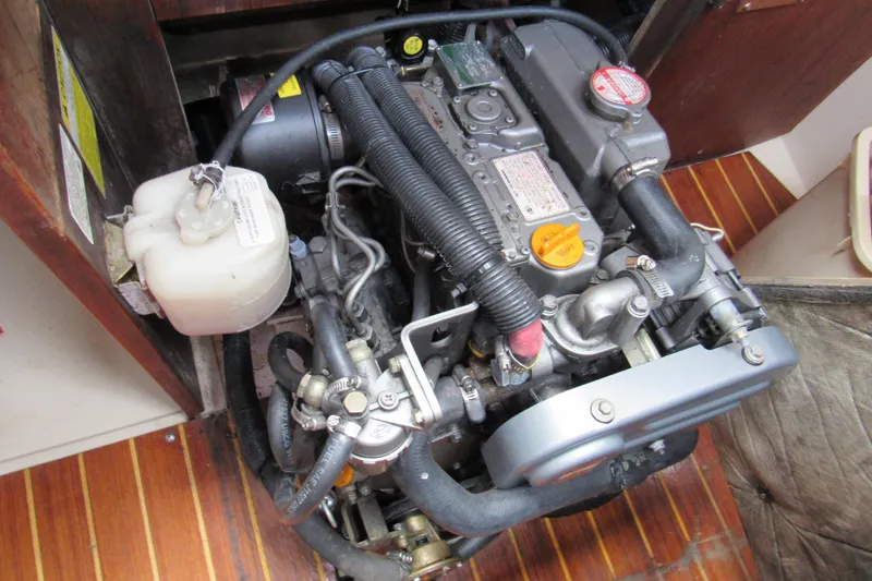 Slide: The Image of Engine of a 1986 Catalina 36 sailboat, showing detailed components and hoses. - 14
