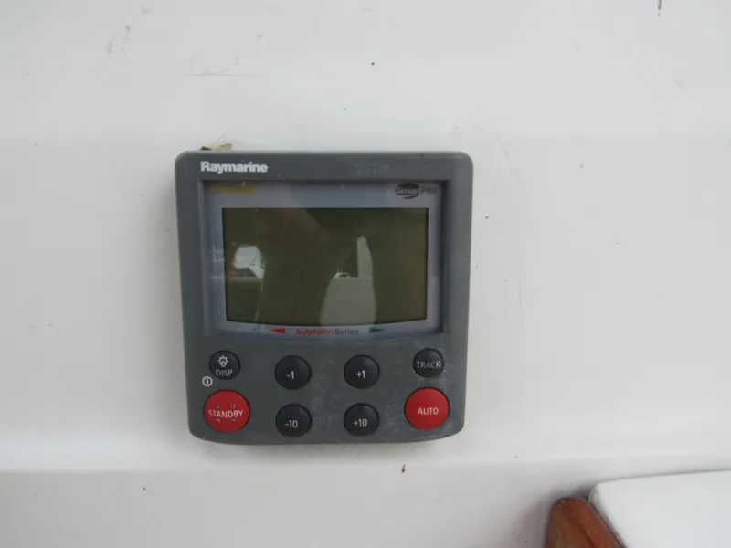 Slide: The Image of Raymarine autopilot control on 1986 Catalina 36 sailboat, featuring display and navigation buttons. - 4