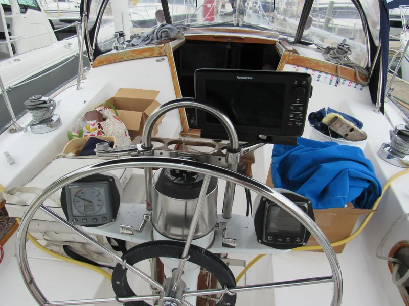 Slide: The Image of Cockpit of a 1986 Catalina 36 sailboat with navigation equipment and steering wheel. - 5
