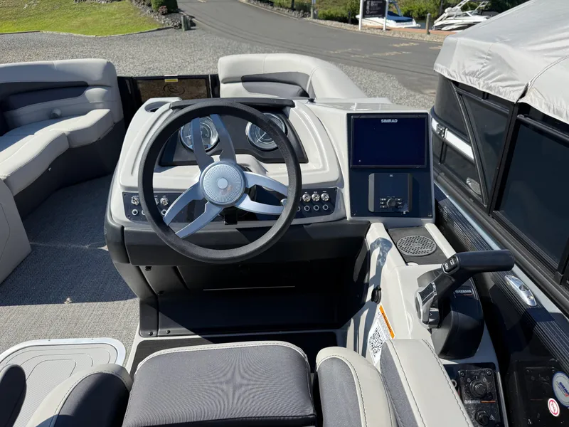 Slide: The Image of 2025 Barletta C22UC boat interior with steering wheel and control panel. - 11