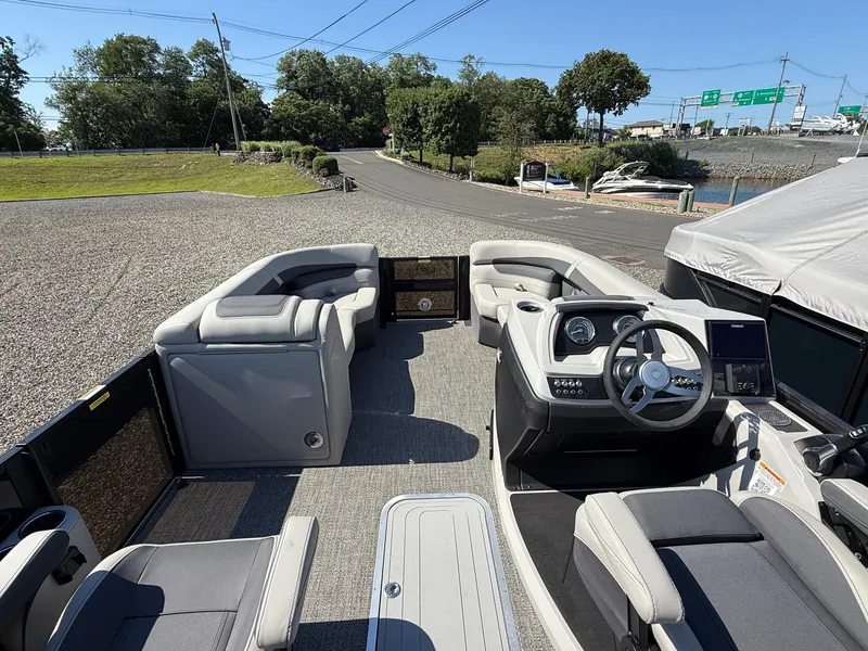 Slide: The Image of 2025 Barletta C22UC pontoon boat interior with modern seating and steering console. - 13