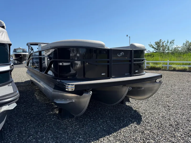 Slide: The Image of 2025 Barletta C22UC pontoon boat on gravel lot under clear blue sky. - 4