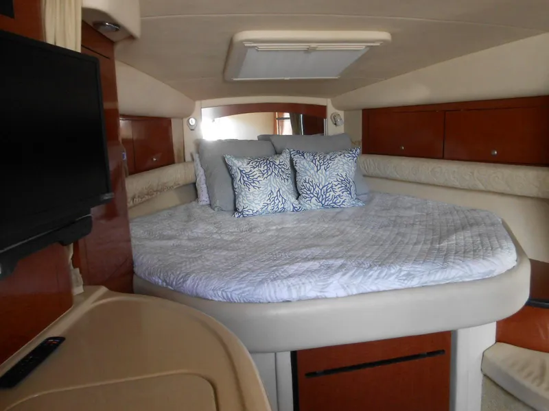 Slide: The Image of Luxurious cabin interior of 2005 Sea Ray 340 Sundancer with cozy bed and TV. - 15