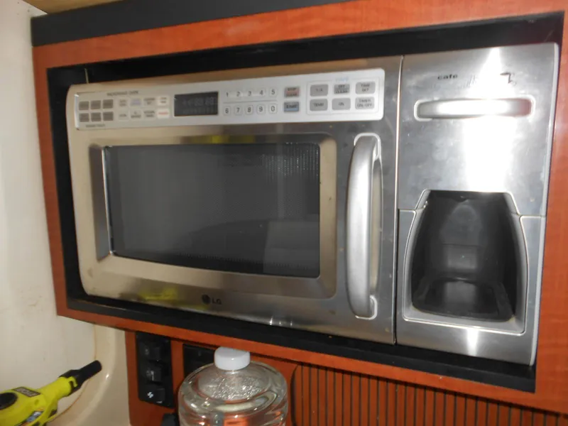 Slide: The Image of Built-in microwave and coffee maker on a 2005 Sea Ray 340 Sundancer yacht. - 18