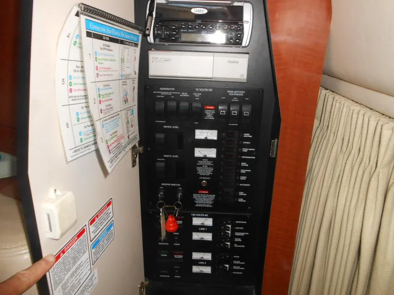 Slide: The Image of Electrical control panel inside a 2005 Sea Ray 340 Sundancer boat cabin. - 26
