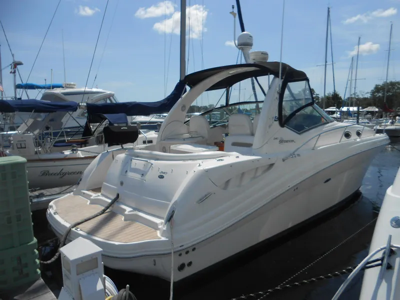 Slide: The Image of 2005 Sea Ray 340 Sundancer yacht docked at marina under clear sky. - 3