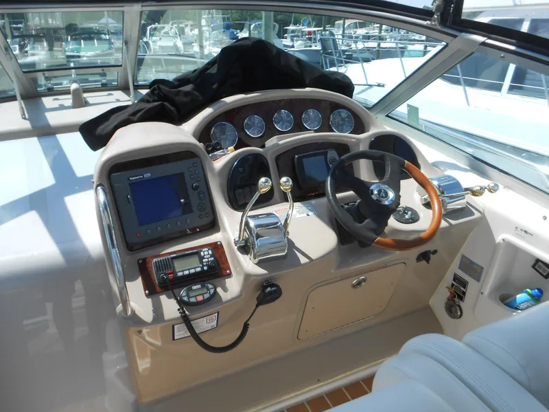 Slide: The Image of 2005 Sea Ray 340 Sundancer helm with steering wheel, gauges, and navigation equipment. - 7