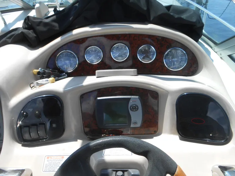 Slide: The Image of Dashboard of 2005 Sea Ray 340 Sundancer boat with gauges and navigation system. - 9