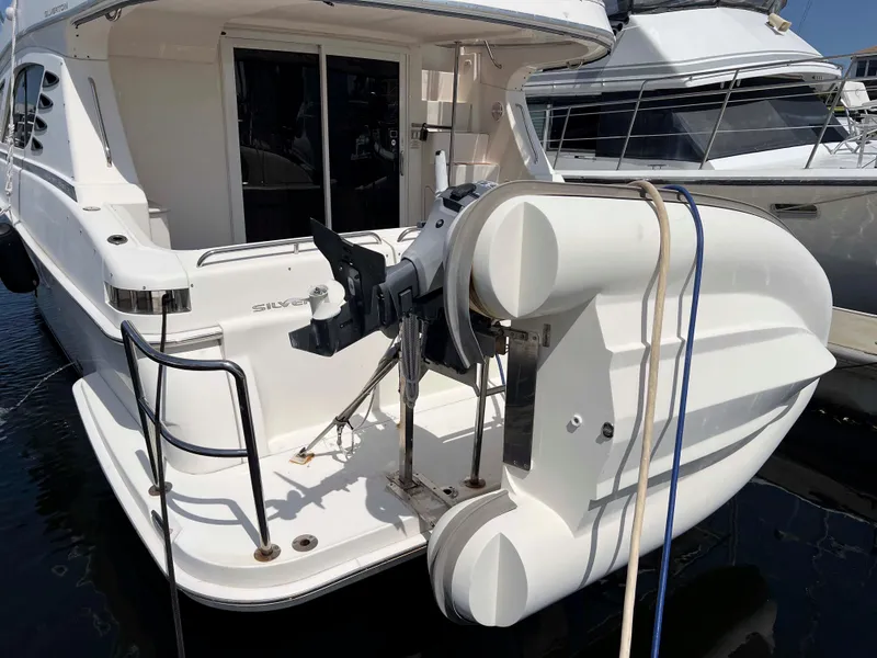 Slide: The Image of 2005 Silverton 38 Sport Bridge yacht with attached dinghy at marina. - 10