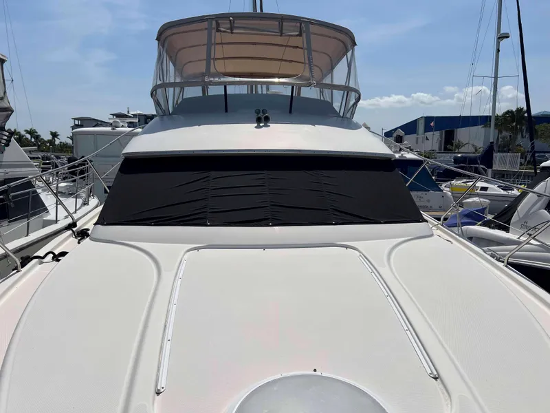 Slide: The Image of 2005 Silverton 38 Sport Bridge yacht docked at marina under clear sky. - 14