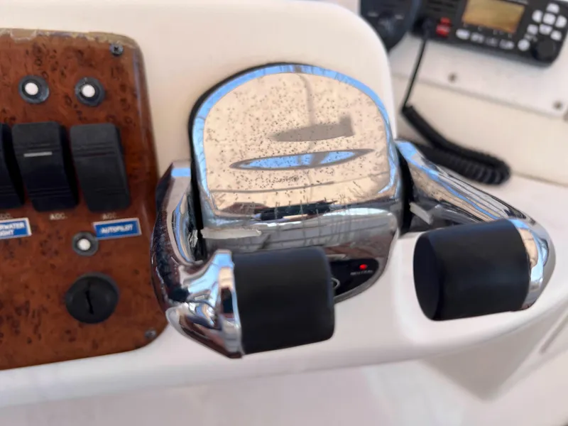 Slide: The Image of Close-up of 2005 Silverton 38 Sport Bridge throttle controls and dashboard switches. - 21