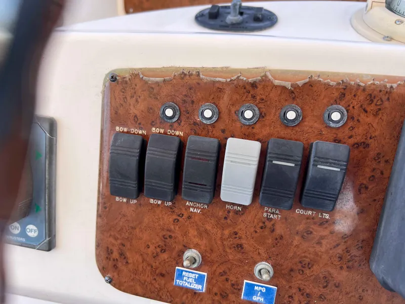 Slide: The Image of Control panel of a 2005 Silverton 38 Sport Bridge with various switches and buttons. - 24