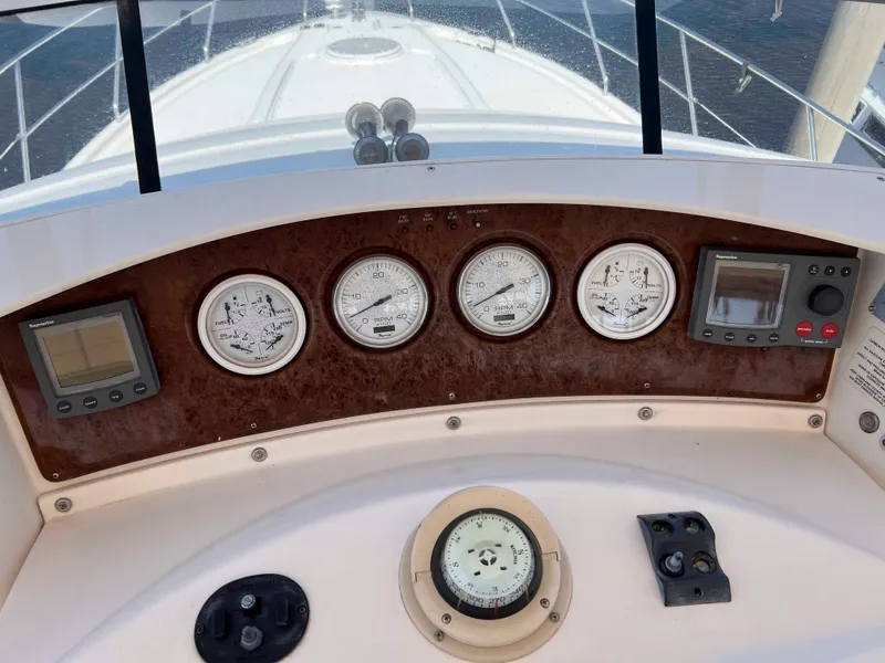 Slide: The Image of 2005 Silverton 38 Sport Bridge dashboard with gauges and navigation equipment. - 27