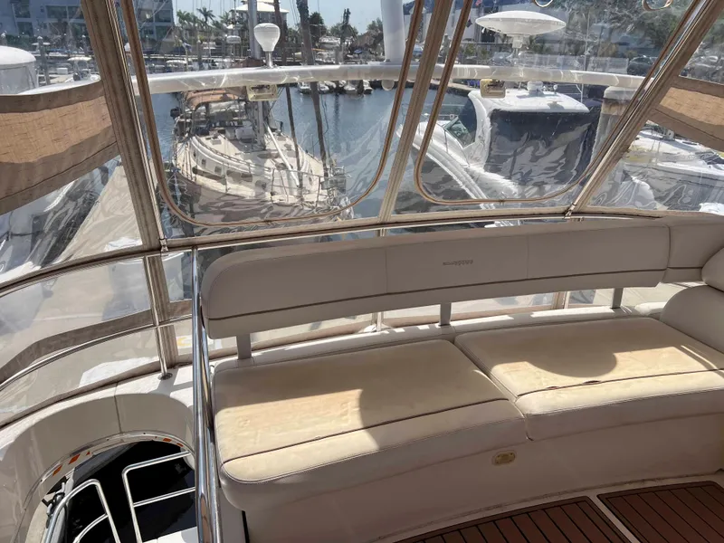 Slide: The Image of 2005 Silverton 38 Sport Bridge yacht interior with marina view through clear windows. - 35