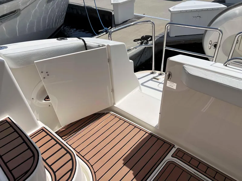 Slide: The Image of 2005 Silverton 38 Sport Bridge boat deck with open gate and wood-patterned flooring. - 38