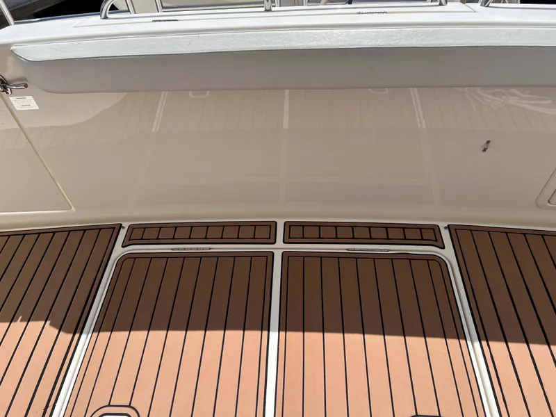 Slide: The Image of 2005 Silverton 38 Sport Bridge deck with teak flooring and white railing. - 39