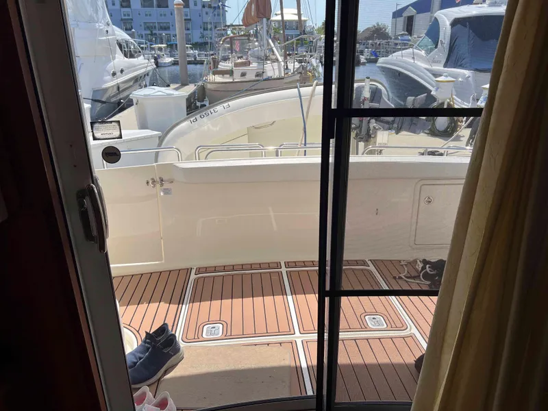 Slide: The Image of 2005 Silverton 38 Sport Bridge yacht interior view with marina background. - 40