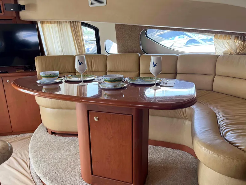 Slide: The Image of Luxurious interior of 2005 Silverton 38 Sport Bridge yacht with elegant dining setup. - 41