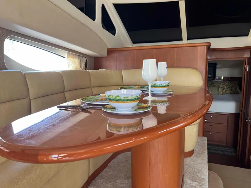 Slide: The Image of Interior of 2005 Silverton 38 Sport Bridge yacht with elegant dining setup. - 43