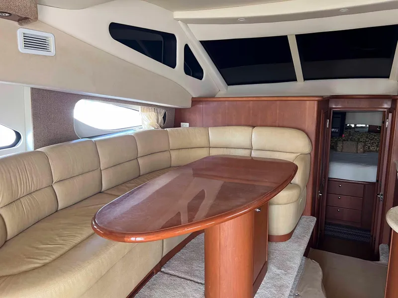 Slide: The Image of Luxurious interior of a 2005 Silverton 38 Sport Bridge yacht with plush seating and wooden table. - 44