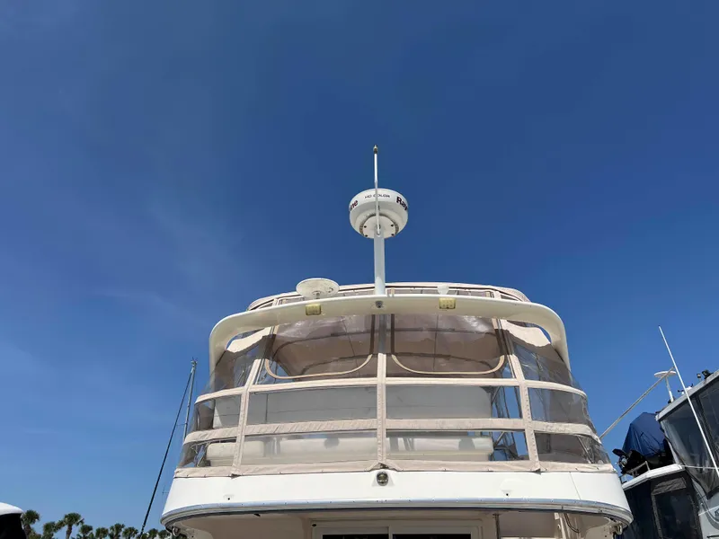 Slide: The Image of 2005 Silverton 38 Sport Bridge yacht under clear blue sky. - 6