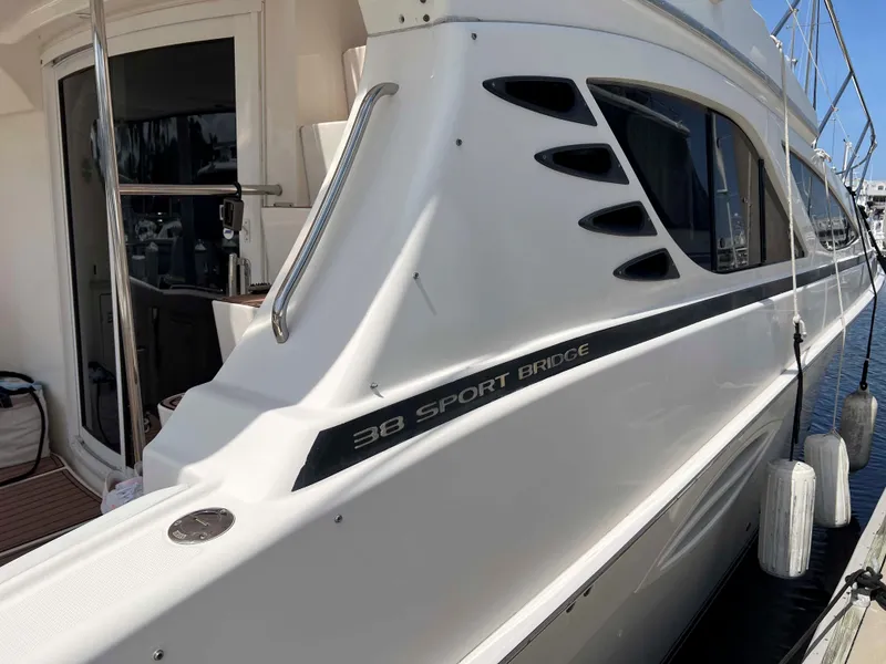 Slide: The Image of 2005 Silverton 38 Sport Bridge yacht docked, showcasing sleek design and modern features. - 7