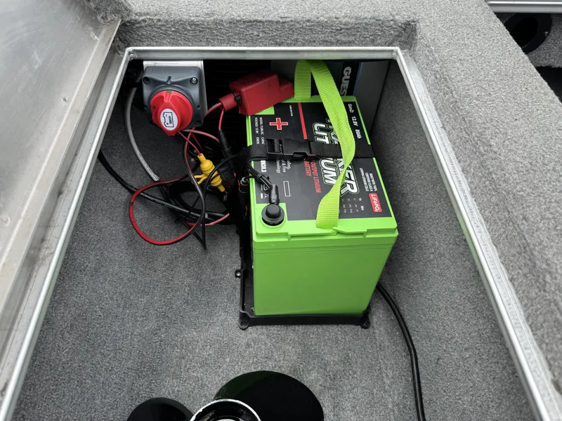 Slide: The Image of Battery compartment of 2012 Tracker Pro Team 175 TXW boat with green lithium battery. - 10