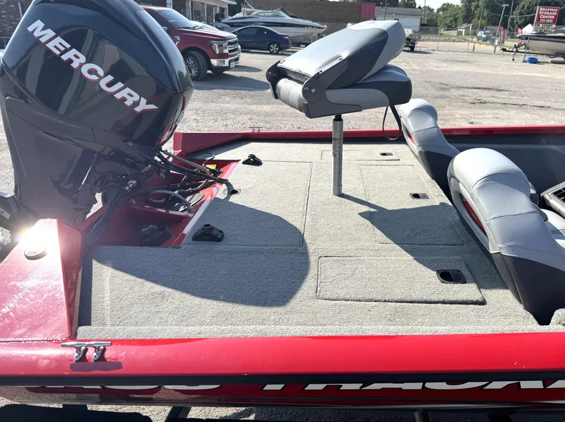 Slide: The Image of 2012 Tracker Pro Team 175 TXW boat with Mercury engine, red exterior, and gray seating. - 11