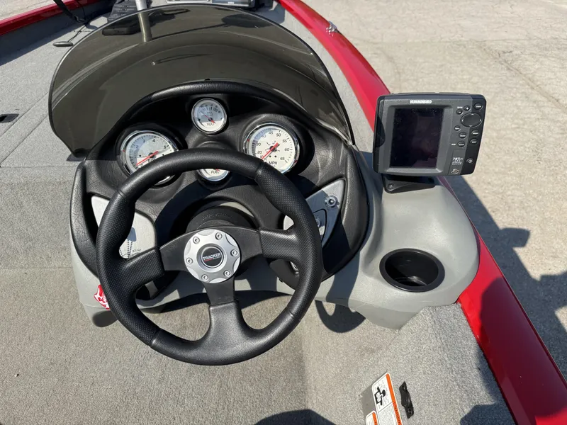 Slide: The Image of 2012 Tracker Pro Team 175 TXW boat dashboard with steering wheel and gauges. - 12