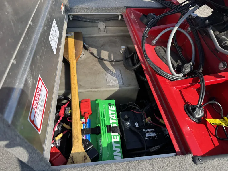Slide: The Image of 2012 Tracker Pro Team 175 TXW boat battery compartment with cables and paddle. - 15