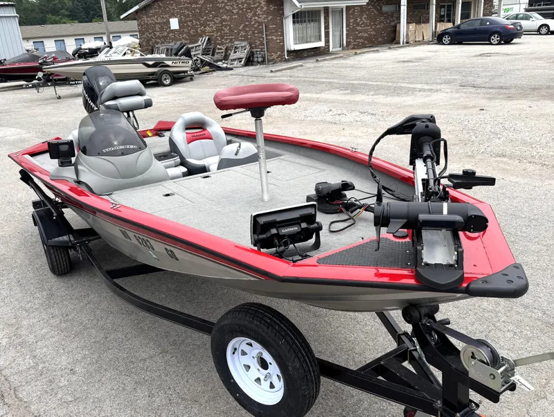 Slide: The Image of 2012 Tracker Pro Team 175 TXW boat with red accents and fishing equipment. - 4