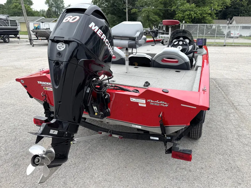Slide: The Image of 2012 Tracker Pro Team 175 TXW boat with Mercury 60 engine, red exterior, parked outdoors. - 5