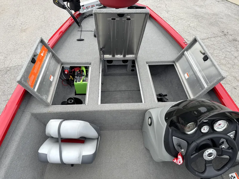 Slide: The Image of 2012 Tracker Pro Team 175 TXW boat interior with open storage compartments and steering console. - 7