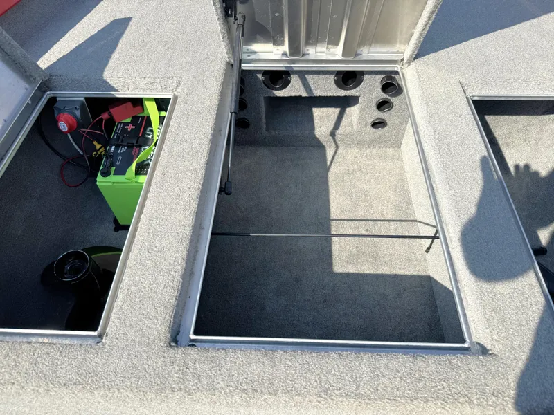 Slide: The Image of 2012 Tracker Pro Team 175 TXW boat storage compartments with battery visible. - 8