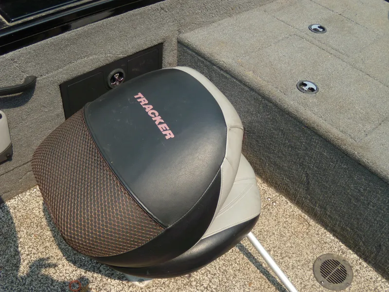 Slide: The Image of 2015 Tracker Targa V-18 WT boat seat with logo, gray carpeted deck. - 11