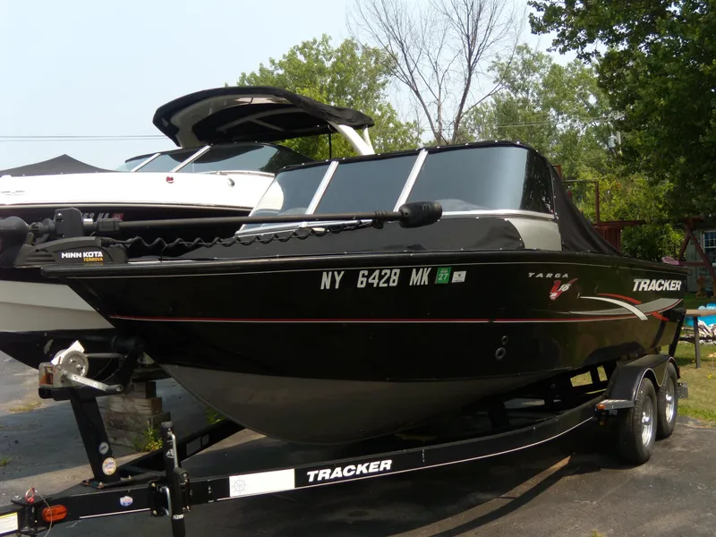 Slide: The Image of 2015 Tracker Targa V-18 WT boat on trailer, black exterior, parked outdoors. - 2