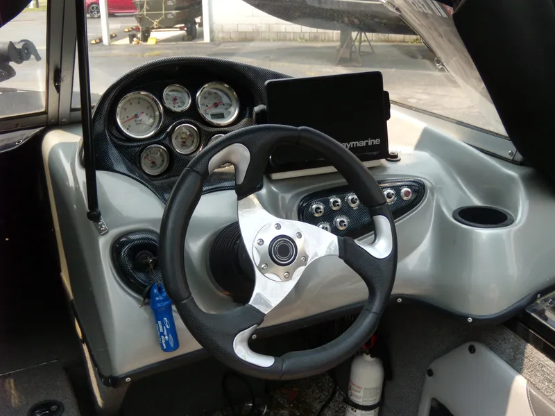 Slide: The Image of 2015 Tracker Targa V-18 WT dashboard with steering wheel and gauges. - 4