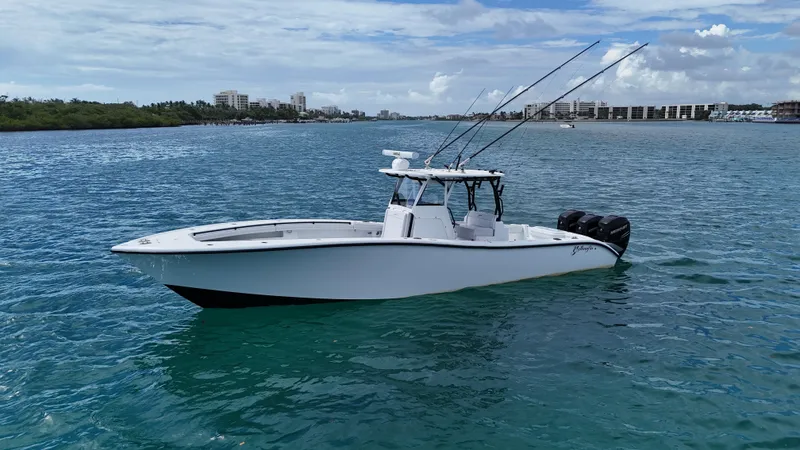 Slide: The Image of 2017 Yellowfin 36 Offshore boat on calm blue water, clear sky background. - 10